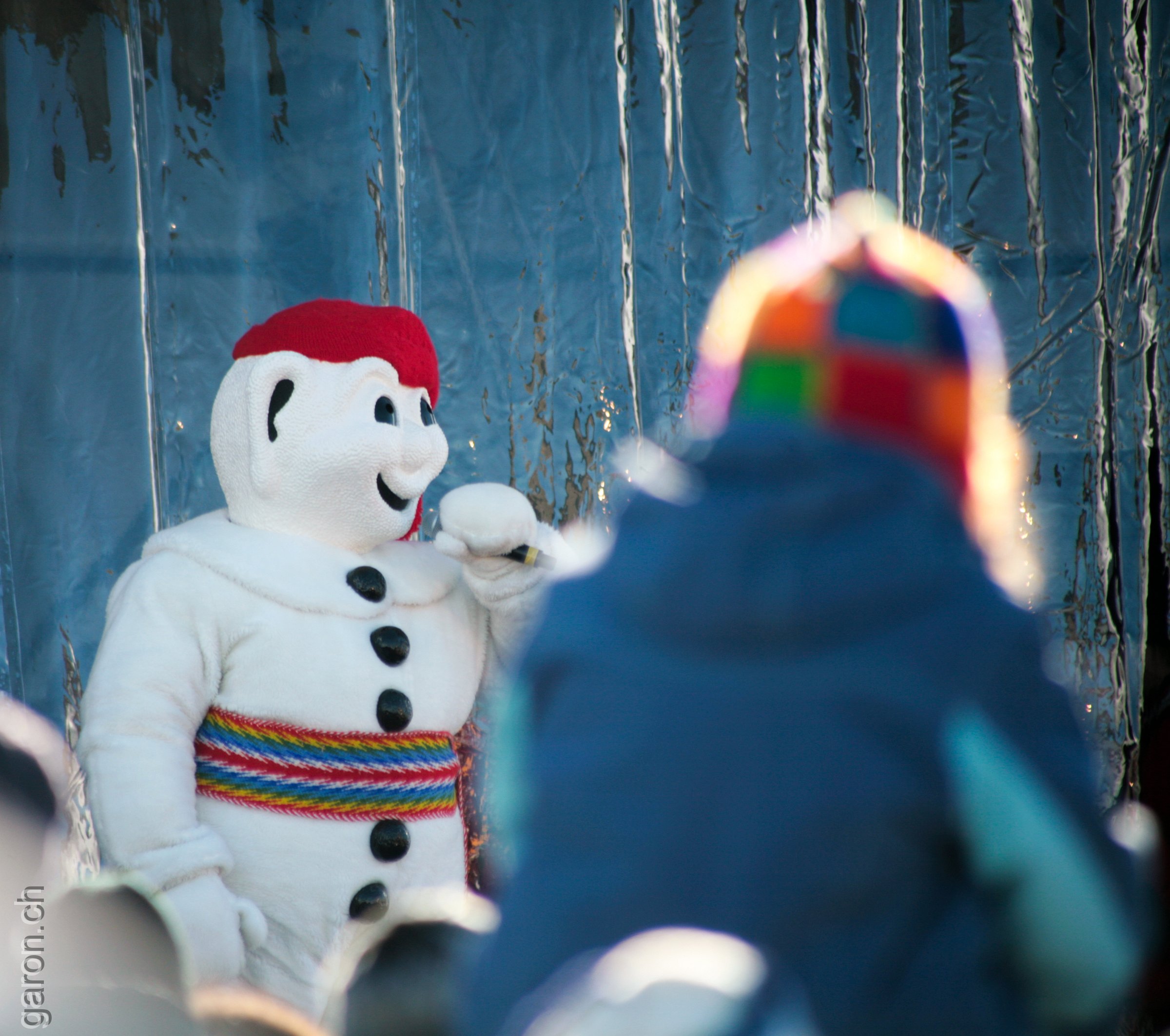 Québec, Carnaval Child admires Bonhomme Carnaval, the mascot of Carnival season