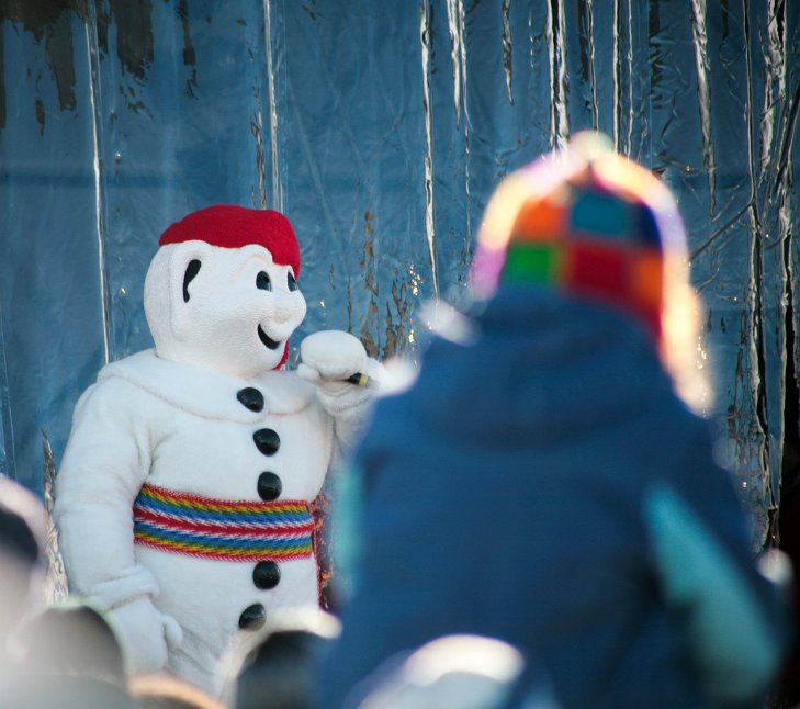Carnaval Québec Child admires Bonhomme Carnaval, the mascot of Carnival season
