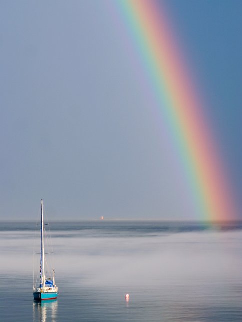 Sailboat and rainbow in the small bay of Tadoussac,